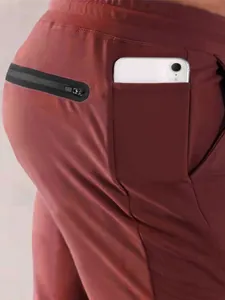 Men's athletic joggers featuring a side phone pocket and back zipper pocket detail