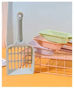 Group of macaron-colored cat litter scoops with hollowed-out grid design for pet cleaning