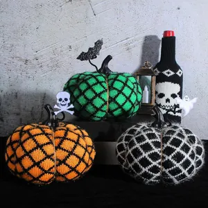 Set of three handmade knitted pumpkins with diamond patterns for Halloween party decor