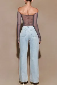 Back view of sexy sheer mesh long sleeve top paired with light blue wide leg denim jeans