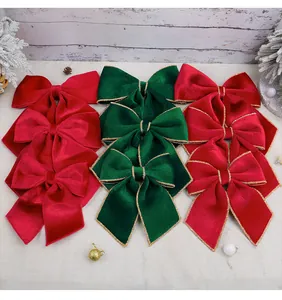 Detailed view of red and green velvet Christmas bows with elegant gold edging.