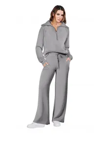 Women's grey two-piece casual sports set with half-zip sweatshirt and wide-leg pants.