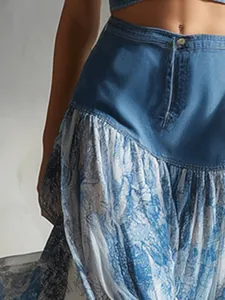 Close-up of blue denim and vintage printed chiffon patchwork midi skirt detail