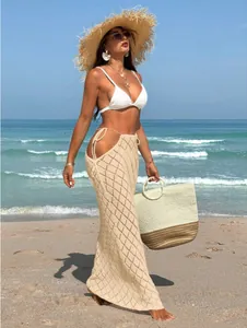 Detailed view of the beige crochet knit maxi skirt with side cut-outs and lace-up ties.