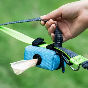 Durable blue canvas pet waste bag dispenser attached to a dog leash for outdoor walking