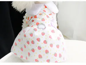 Close-up detail of a strawberry print pet dress featuring a metal D-ring leash hook.