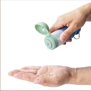 Close-up of portable pet hand sanitizer dispenser dispensing liquid into a palm