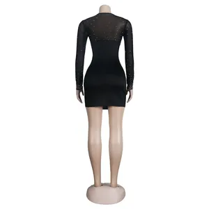 Back view of a black bodycon dress featuring sheer mesh sleeves and rhinestone detail.