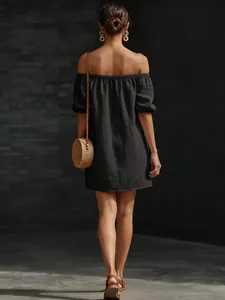 Back view of elegant black cotton-linen off-the-shoulder mini dress with puff sleeves