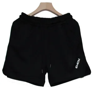 Front view of men's black quick-dry athletic shorts with drawstring on a hanger