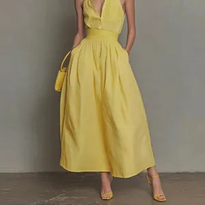 Close-up detail of yellow striped sleeveless maxi dress featuring a deep V-neckline and cinched waist