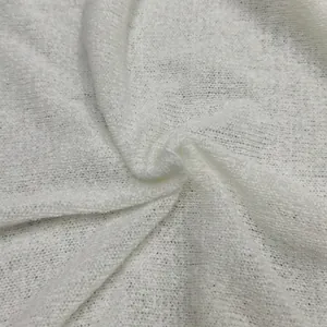 Macro detail of white sheer knitted fabric texture with delicate and soft crochet patterns