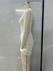 Side view of white knitted backless mini dress with drawstring ruched detail on mannequin.