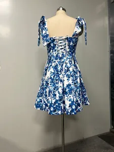 Detail view of the elegant blue floral dress featuring a corset lace-up back design.