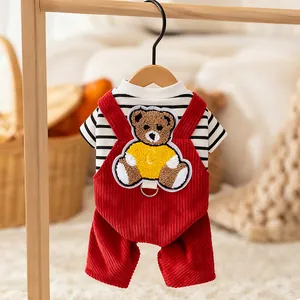 Detailed view of red corduroy pet overalls featuring a cute teddy bear embroidery patch