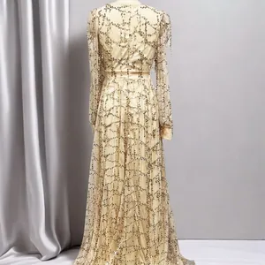 Detailed back view of an elegant champagne gold sequined mesh evening gown with long sleeves