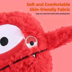 Red furry monster plush dog toy featuring large eyes and soft texture for interactive pet play