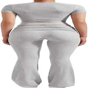 Back view of grey two-piece sportswear set including crop top and flared yoga pants