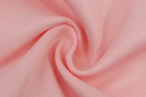 Macro view of soft pink blazer fabric showing fine woven texture details