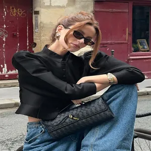 Elegant vintage puff sleeve matte satin blouse with stand collar shown in street scene