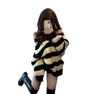 Stylish women's oversized black and white striped knit sweater for a cozy autumn look