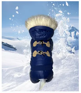 Premium blue dog winter coat with toggle buttons and fur hood in snowy mountain scene.