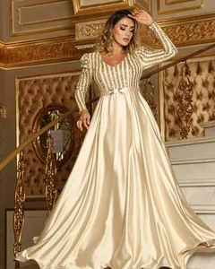 Elegant champagne evening gown with deep V-neck, sequined stripes, and satin skirt.