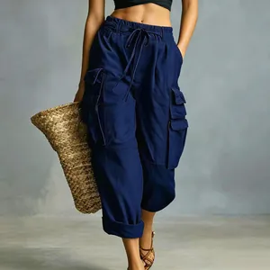 Close-up of navy blue high-waisted cargo pants with drawstring and large pockets.