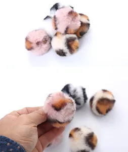 Close-up of soft leopard print faux fur pom-pom toy for interactive cat play