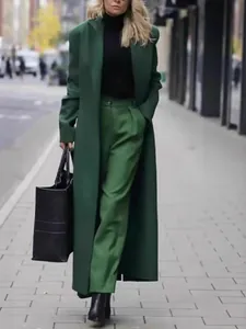 Elegant long dark green wool coat for women in a street style winter fashion look