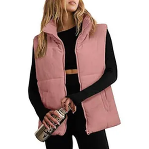 Close-up of a women's pink corduroy puffer vest with quilted design and front zipper