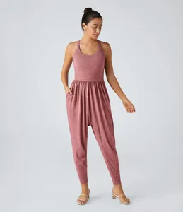 Full front detail of women's sleeveless dusty rose harem jumpsuit with side pockets