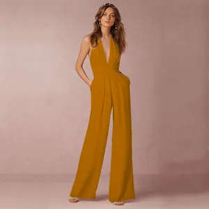 Full body view of a stylish mustard yellow halter neck jumpsuit with wide legs.