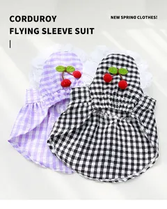 Detailed view of lightweight gingham pet dresses with cute cherry ornaments and lace edges