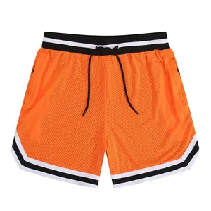 Orange mesh athletic shorts with striped waistband and drawstring details