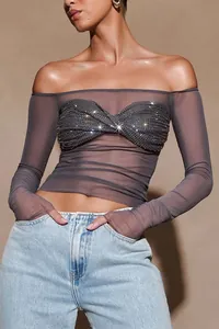 Detail of sheer long sleeve off-the-shoulder crop top with sparkling sequin bust