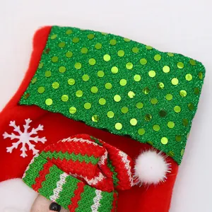 Close-up of a festive Christmas stocking with green sequins and a Santa Claus motif