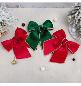 Close-up of large red and green velvet Christmas bows with elegant gold glitter trim