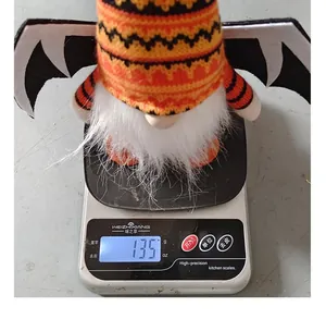 Close-up detail showing the 135g weight of a Halloween gnome plush toy with bat wings
