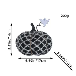 Handmade black and white knitted pumpkin with small ghost for Halloween party decor