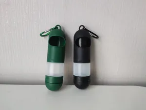Capsule-shaped pet waste bag dispenser with carabiner in green and black colors.
