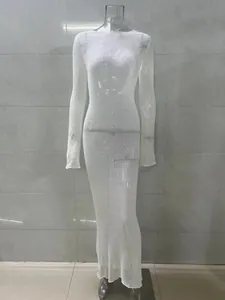 Detail view of a sexy sheer white long-sleeved knit maxi dress displayed on a mannequin