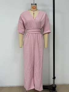 Elegant pink V-neck jumpsuit with cinched waist and pleated textured fabric detail