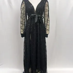 Front view of a black sequin mesh evening gown with a satin bow belt on a mannequin