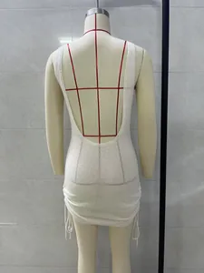 Back view of a white knitted mini dress featuring a sexy backless design on a mannequin