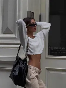 Fashionable white cropped knit sweater for women with a sexy raw edge street style