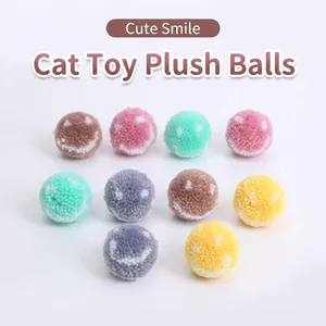 Soft macaron colored plush cat toy balls featuring cute smiley face patterns for indoor play