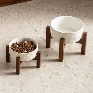 White ceramic pet bowl set with paw prints and raised wooden stands