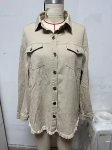 Macro view of beige washed denim shirt jacket with frayed hem details on a mannequin.