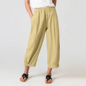 Close-up of loose-fitting cotton linen harem pants with high elastic waist and cropped length
